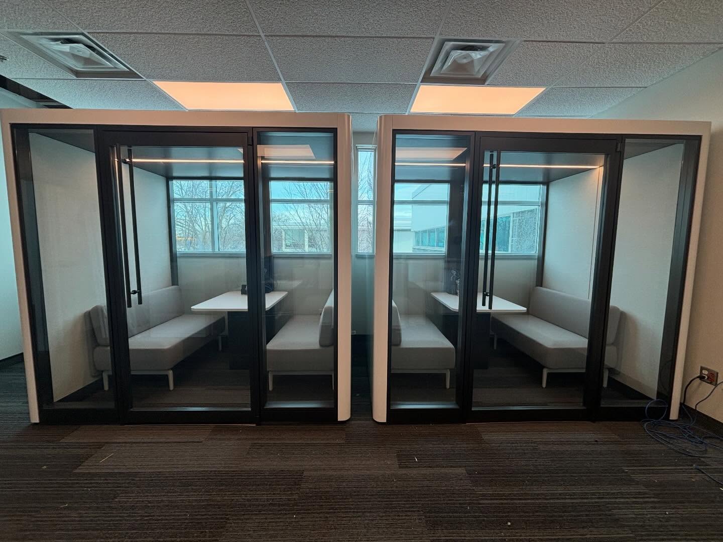 Two enclosed workplace booths side by side