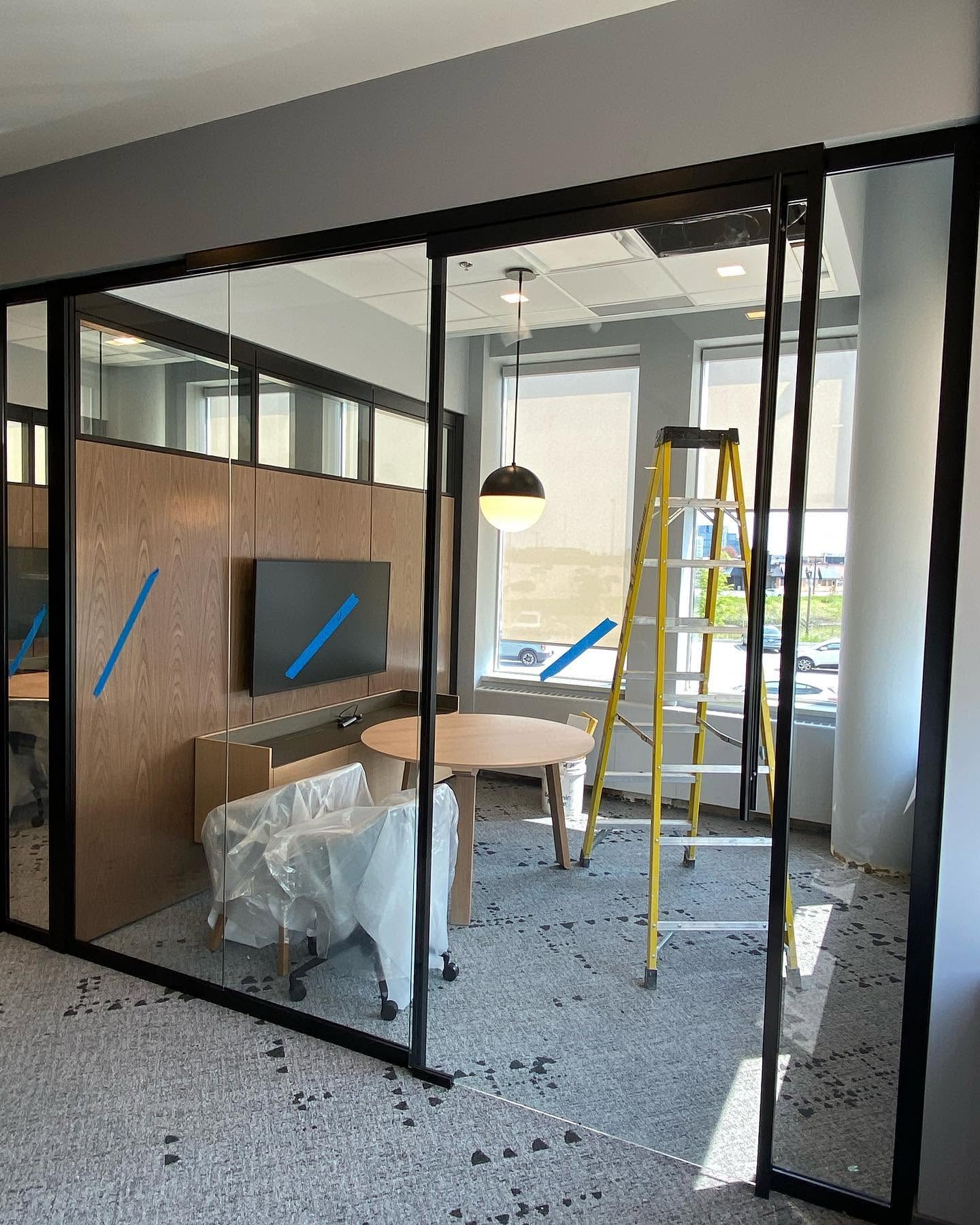 Black-framed glass meeting room being finished